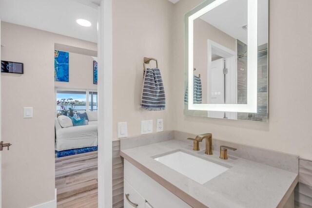 bathroom with ensuite bath and vanity