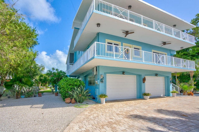 view of front of property with ceiling fan and a garage