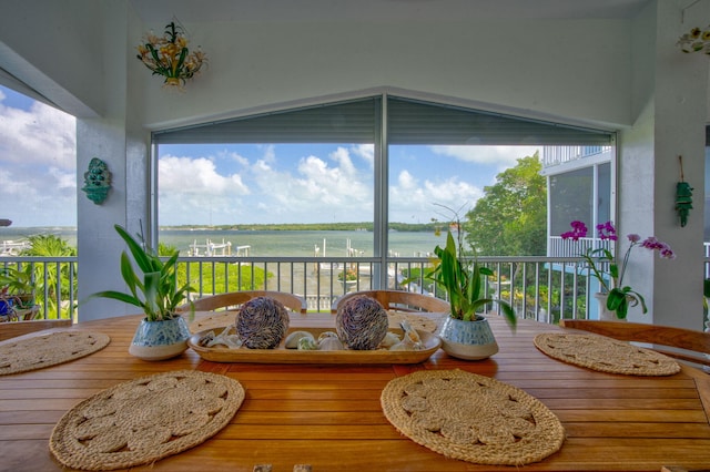 sunroom / solarium with a water view