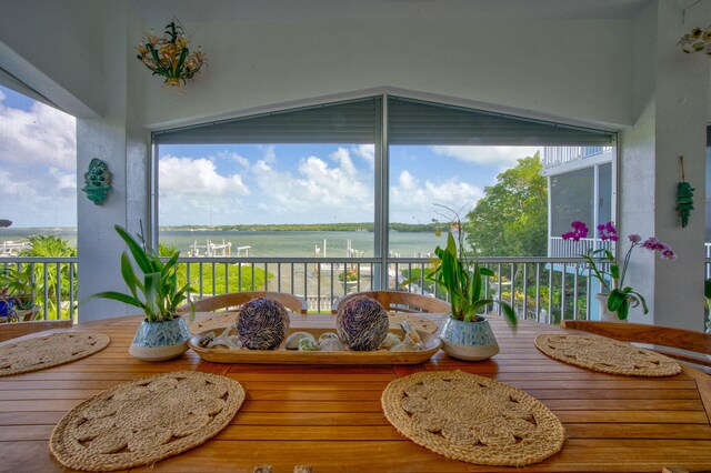 sunroom / solarium with a water view