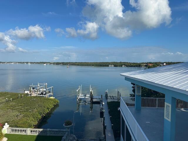 property view of water featuring a boat dock and boat lift