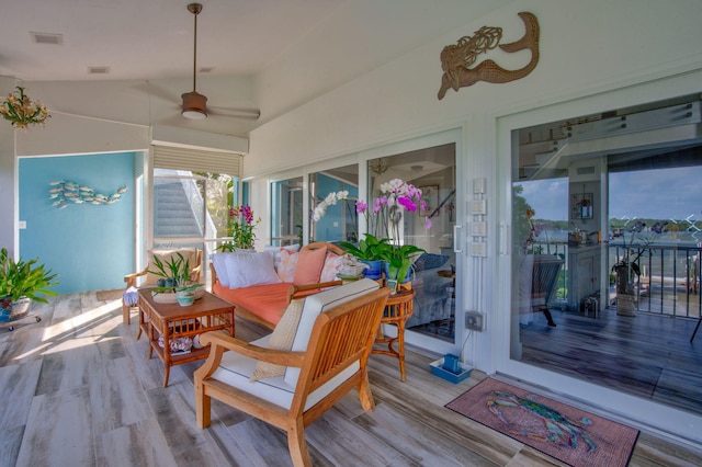 wooden terrace featuring visible vents, an outdoor living space, and a ceiling fan