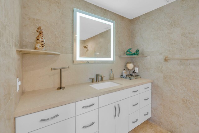 bathroom with vanity, tile walls, and tile patterned floors