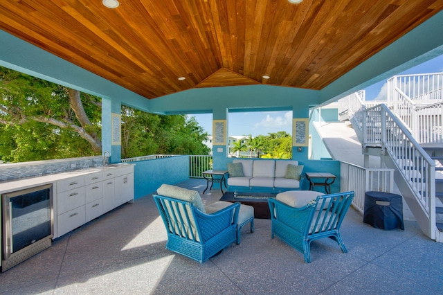 view of patio / terrace with an outdoor living space, sink, beverage cooler, and exterior kitchen