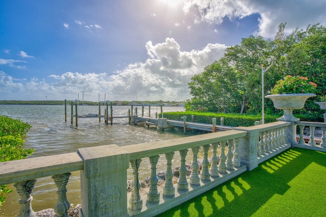 dock area with a water view and boat lift