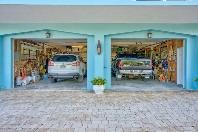 garage featuring decorative driveway