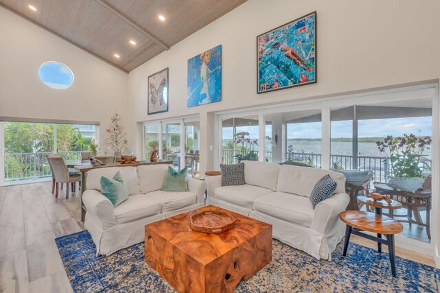 living room featuring a water view, wood ceiling, high vaulted ceiling, and a wealth of natural light