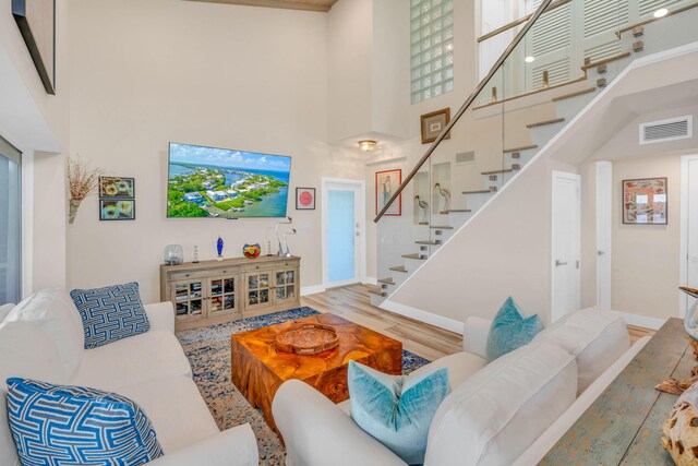 living room featuring hardwood / wood-style floors and a high ceiling