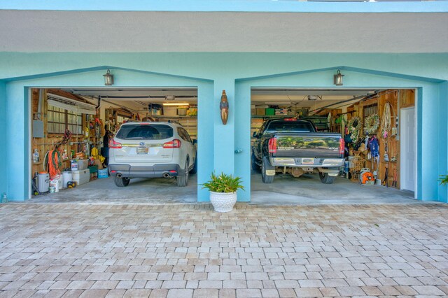 garage with decorative driveway