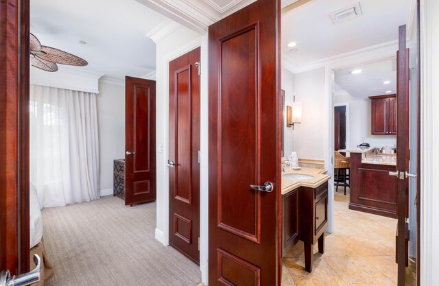 81801 Overseas Hwy Unit 754, Islamorada, FL 33036 - hall with ornamental molding, a sink, recessed lighting, baseboards, and light colored carpet