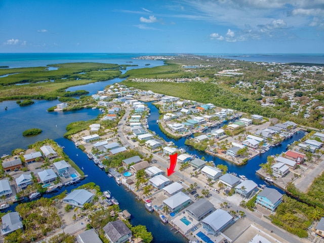 drone / aerial view featuring a water view and a residential view