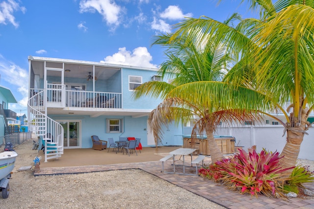 back of house featuring a ceiling fan, a hot tub, stairs, a patio area, and stucco siding