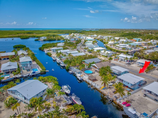 drone / aerial view with a water view and a residential view