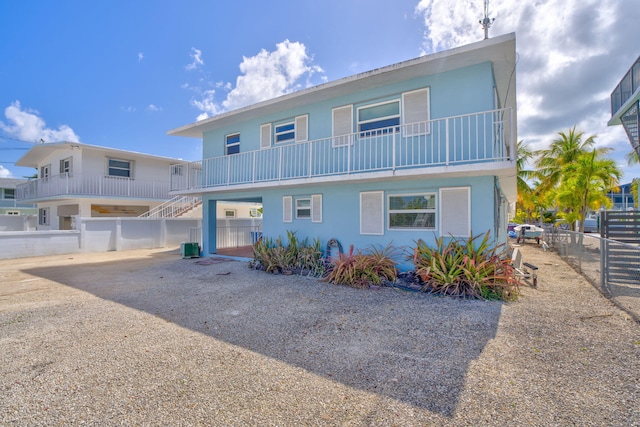 view of front of house featuring fence, stucco siding, and cooling unit