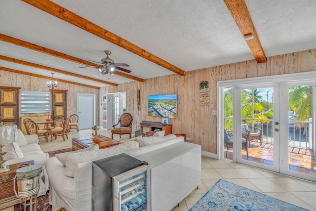 living area featuring a wealth of natural light, french doors, and beam ceiling