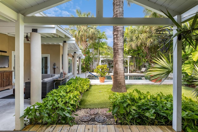 view of yard featuring outdoor lounge area, a fenced in pool, and a patio