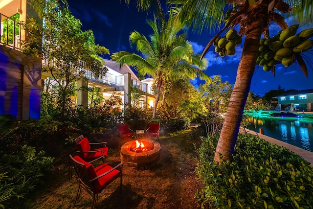 yard at night featuring an outdoor fire pit