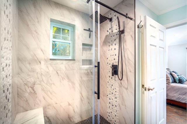 bathroom with a shower with shower door and ornamental molding