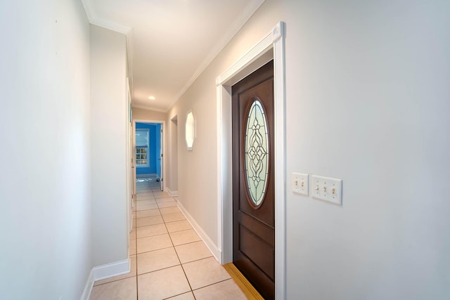 doorway featuring ornamental molding and light tile patterned floors