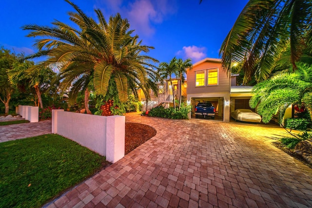 view of front of property featuring a carport and a garage