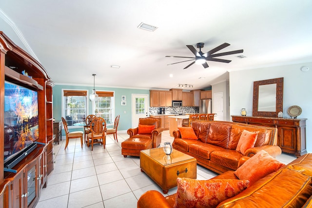 tiled living room featuring ornamental molding and ceiling fan