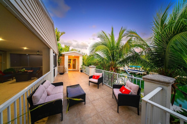 patio terrace at dusk with a shed and a balcony