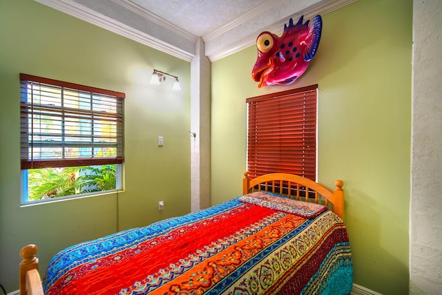 bedroom with ornamental molding and a textured ceiling