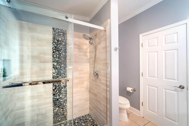 bathroom featuring a shower with door, crown molding, tile patterned floors, and toilet