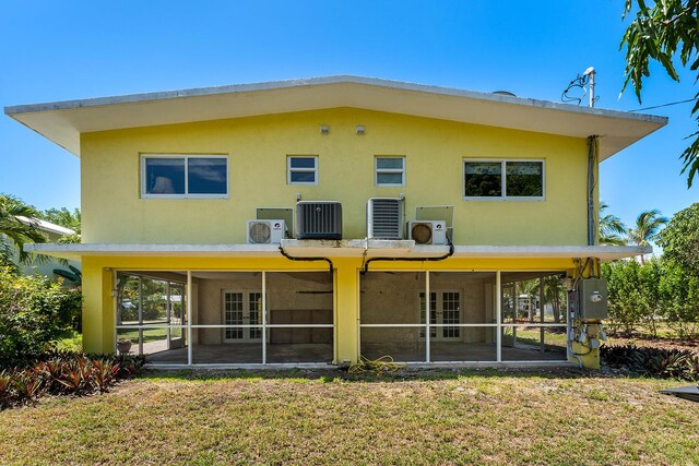 back of property featuring a sunroom, central AC, and a patio area