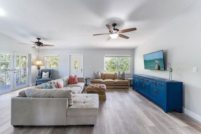 living room with french doors, ceiling fan, and light hardwood / wood-style flooring