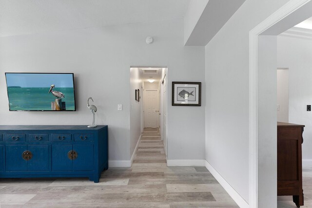 hallway with light hardwood / wood-style floors