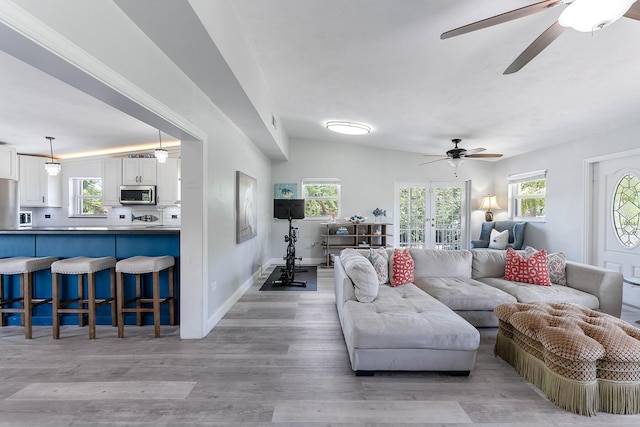 living room with ceiling fan and light hardwood / wood-style flooring