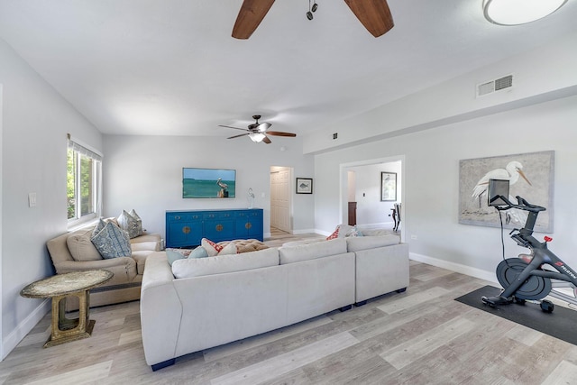 living room with light hardwood / wood-style floors and ceiling fan