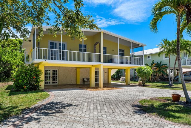 view of front facade with a carport and french doors