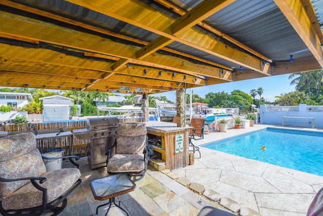 view of swimming pool featuring exterior bar and a patio area