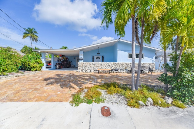 single story home featuring a carport