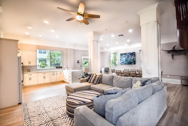 living area with light wood finished floors, decorative columns, visible vents, ceiling fan, and recessed lighting