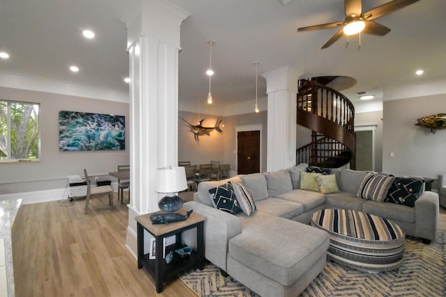 living room featuring recessed lighting, ceiling fan, stairs, light wood-style floors, and ornate columns