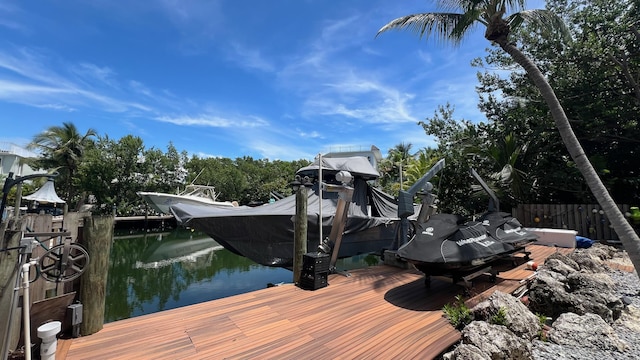 dock area featuring boat lift and fence