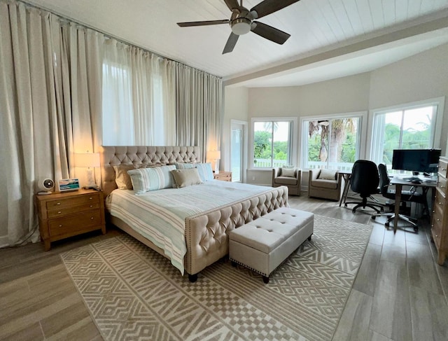 bedroom featuring ceiling fan, beamed ceiling, and light wood-type flooring
