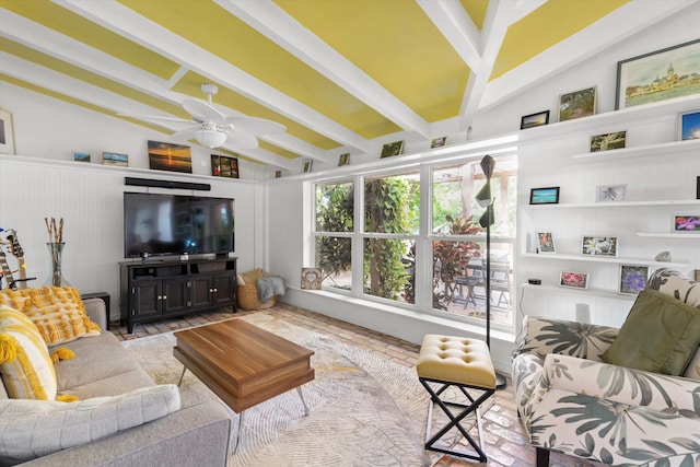 living area with brick floor, lofted ceiling with beams, and a ceiling fan