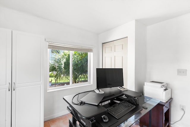 office area featuring light tile patterned floors and baseboards