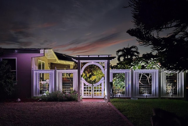 view of back house at dusk