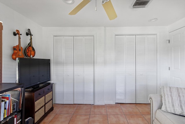 bedroom with light tile patterned floors, ceiling fan, and visible vents