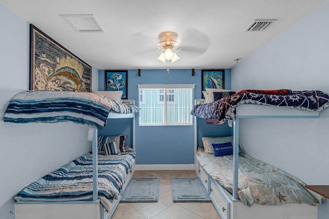 tiled bedroom featuring ceiling fan