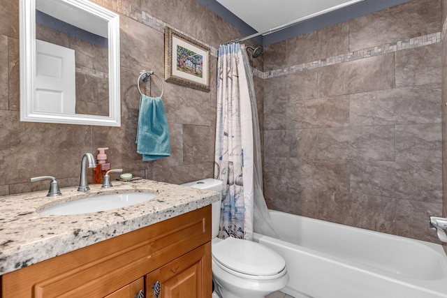 full bathroom with shower / bath combination with curtain, vanity, toilet, and tile walls