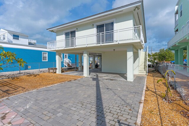 back of house with a carport