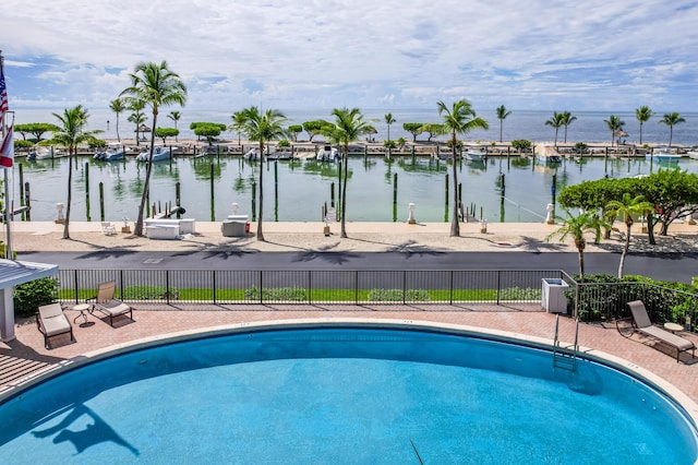 view of pool with a water view