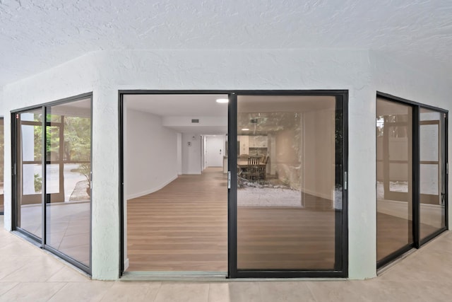 interior space featuring wood-type flooring and a textured ceiling