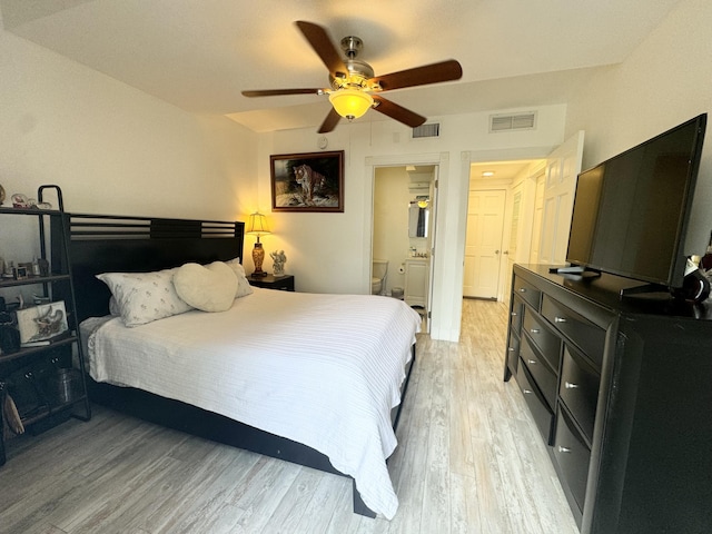 bedroom featuring connected bathroom, visible vents, ceiling fan, and light wood finished floors